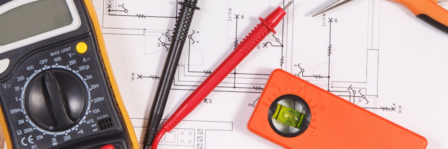 Electrical construction blueprint or diagrams, multimeter for measurement in electrical installation and accessories for engineer jobs